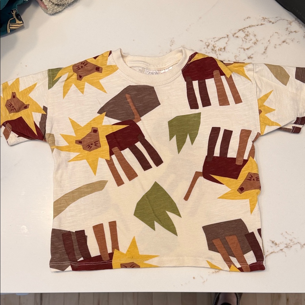 Zara Cream Tee with Lion Graphic and Earth Tone Prints